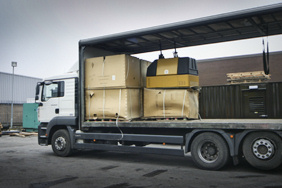 small generator canopies loaded onto a lorry