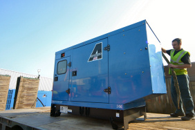silenced generator loaded on a flat back lorry